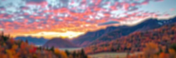 Stunning sunset over mountains with vibrant colors and autumn foliage reflecting in the peaceful valley photo