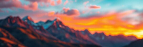 Beautiful sunset over mountain range with colorful clouds illuminating the sky photo
