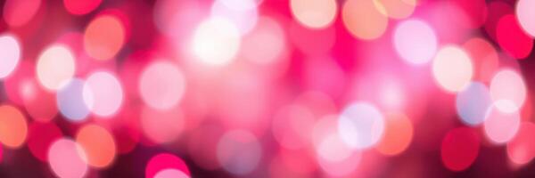 Abstract bokeh lights create a vibrant atmosphere with shades of pink, purple, and white shimmering in the background photo