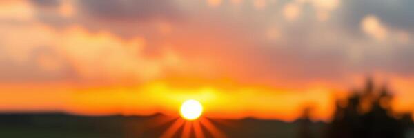 Stunning sunset over a horizon with vibrant colors and rays illuminating the sky during evening hours photo