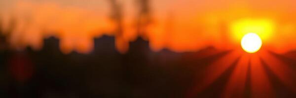 Sunset paints the sky in warm hues above the horizon of a bustling city landscape at dusk photo
