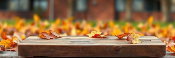 Wooden table surrounded by colorful autumn leaves in tranquil outdoor setting during the fall season photo