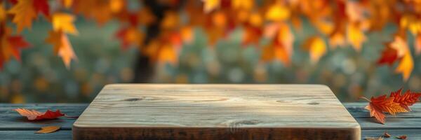 Autumn leaves surround rustic wooden table in a tranquil outdoor setting during golden hour photo