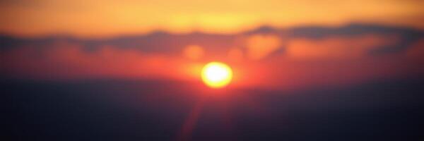 Sunset casts vibrant colors across the sky over a tranquil landscape at dusk photo