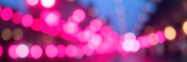 Vibrant pink lights illuminate a bustling street during an evening event in the city photo
