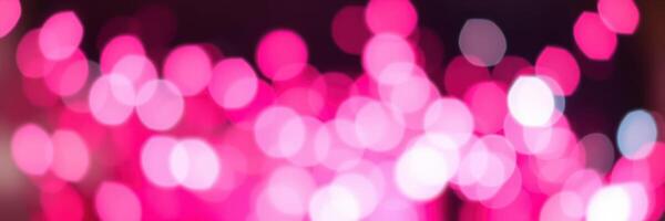 Colorful bokeh lights create a dreamy atmosphere at an evening event with pink and white hues photo
