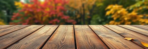 Wooden table foreground contrasting with vibrant autumn foliage in a tranquil outdoor setting photo