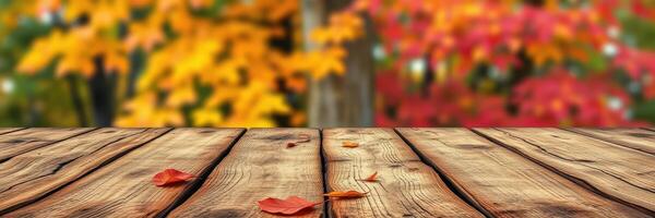 Vibrant autumn leaves create a colorful backdrop for a wooden tabletop in a serene outdoor setting during fall photo