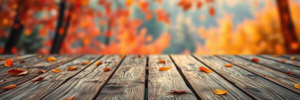 Colorful autumn leaves scattered on a rustic wooden surface in a serene outdoor setting during the fall season photo