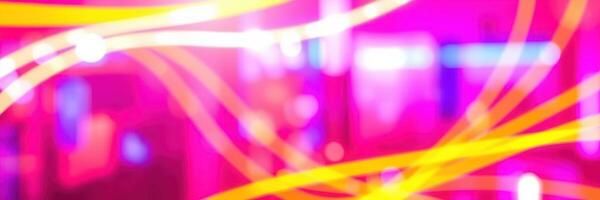 Colorful light trails create an abstract atmosphere in a vibrant urban setting at night photo