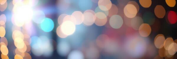Colorful bokeh lights create a festive atmosphere in a city street during an evening celebration photo