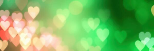 Colorful heart-shaped bokeh lights create a vibrant atmosphere for celebrations and romantic occasions in a lush green background photo