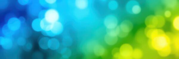 Vibrant bokeh pattern creates a mesmerizing background with blue, green, and yellow hues for artistic design photo