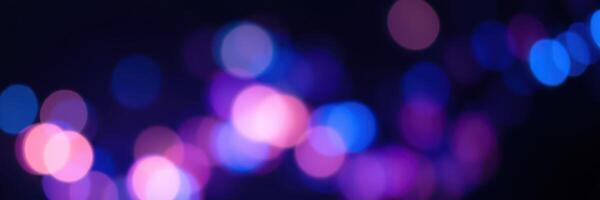 Colorful bokeh lights create a captivating atmosphere at night shimmering in shades of blue and purple photo