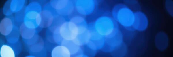 Soft blue bokeh lights create a calming atmosphere for nighttime gatherings and celebrations photo
