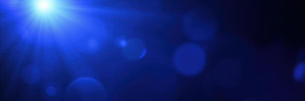 Vibrant blue light creates an ethereal atmosphere in a dimly lit space filled with floating particles photo
