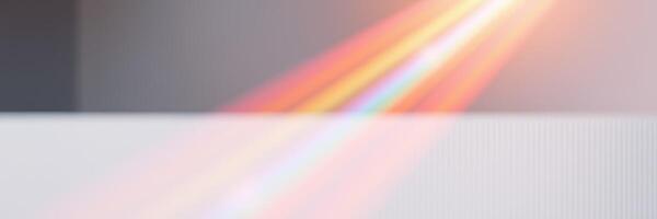 Colorful light refracts through a prism, creating a vibrant spectrum on a surface in a bright indoor setting photo