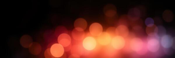 Colorful bokeh lights create a warm ambiance in a dark setting during a festive evening celebration photo