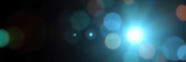 Light particles create a mesmerizing visual effect in a dark environment with vibrant blue highlights and soft bokeh photo