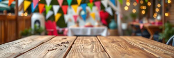 Rustic wooden table adorned with colorful bunting in a festive outdoor setting during a summer gathering photo