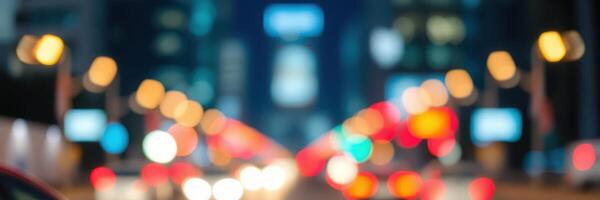 City lights glow brightly on a bustling street during nighttime, with vehicles navigating through a vibrant urban landscape photo