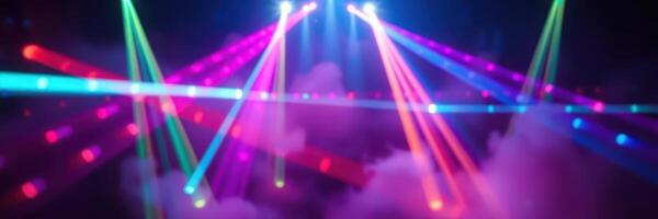 Colorful laser lights dance over a smoke-filled stage during a vibrant music event in a concert hall photo