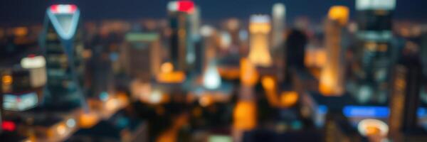 City skyline illuminated at night with blurred lights and buildings creating a vibrant urban atmosphere photo