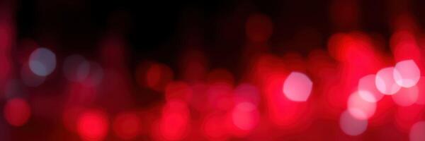 Vibrant red bokeh lights create an abstract atmosphere in a dimly lit space during an evening gathering photo