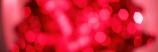 Vibrant red bokeh lights create an enchanting atmosphere for a festive gathering or celebration photo