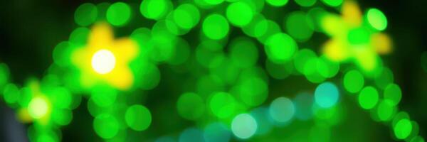 Colorful green lights with yellow stars create a festive atmosphere during a nighttime celebration in a lively outdoor space photo