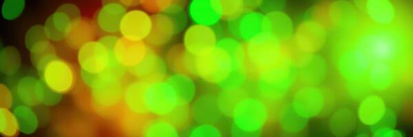 Colorful abstract background with green and yellow bokeh lights creating a festive atmosphere during a celebration photo