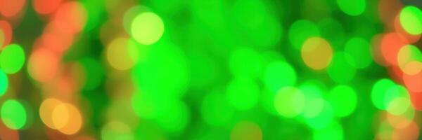 Colorful green and orange bokeh lights create a festive atmosphere during a celebration at night photo