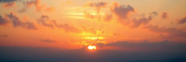 Sunset view from a mountain overlooking the valley with vibrant colors and soft clouds in the sky photo