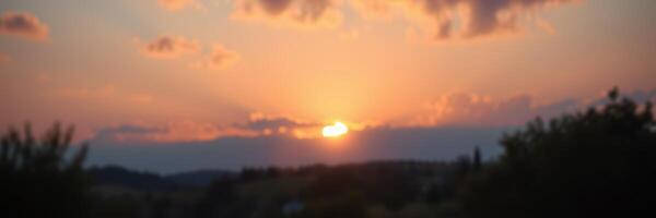 Breathtaking sunset over rolling hills with vibrant clouds and warm colors in the evening sky photo