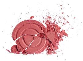 Smashed pink blush cosmetics isolated on white background photo