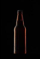 Beer bottle on dark background, copy space photo
