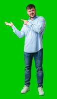 A man gesturing confidently with a bright green background photo