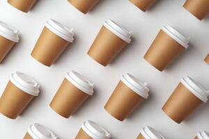 A collection of disposable paper cups arranged in a repeating pattern on a light background photo