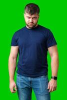Man expressing confusion with crossed arms in front of a bright green background photo