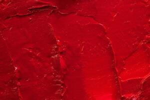 Red lipstick background texture smudged. Close up. photo