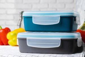 Closed plastic lunch box on kitchen table photo