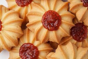 Delicious floral shaped cookies with jam on top, perfect for festive occasions or teatime gatherings photo
