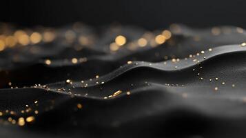 Textured black surface with shimmering gold particles creates a luxurious visual effect photo