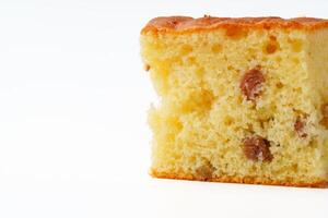Moist cake slice with raisins displayed against a plain white background during a casual baking event photo