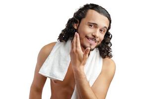Smiling man with curly hair showing confidence while holding a towel photo