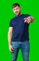 camera while posing in front of a bright green backdrop photo