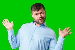 A man playfully posing with a quirky expression against a bright green background photo