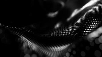 Smoothly flowing black fabric with shimmering dots creates a captivating abstract pattern and texture photo
