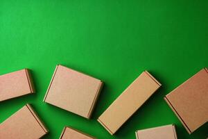 Brown cardboard boxes arranged on a vibrant green surface photo