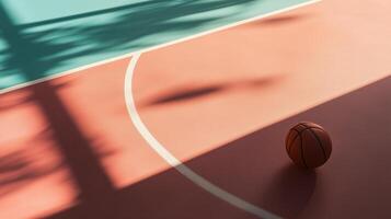 Basketball resting on court surface with shadows cast in evening light during a calm moment photo